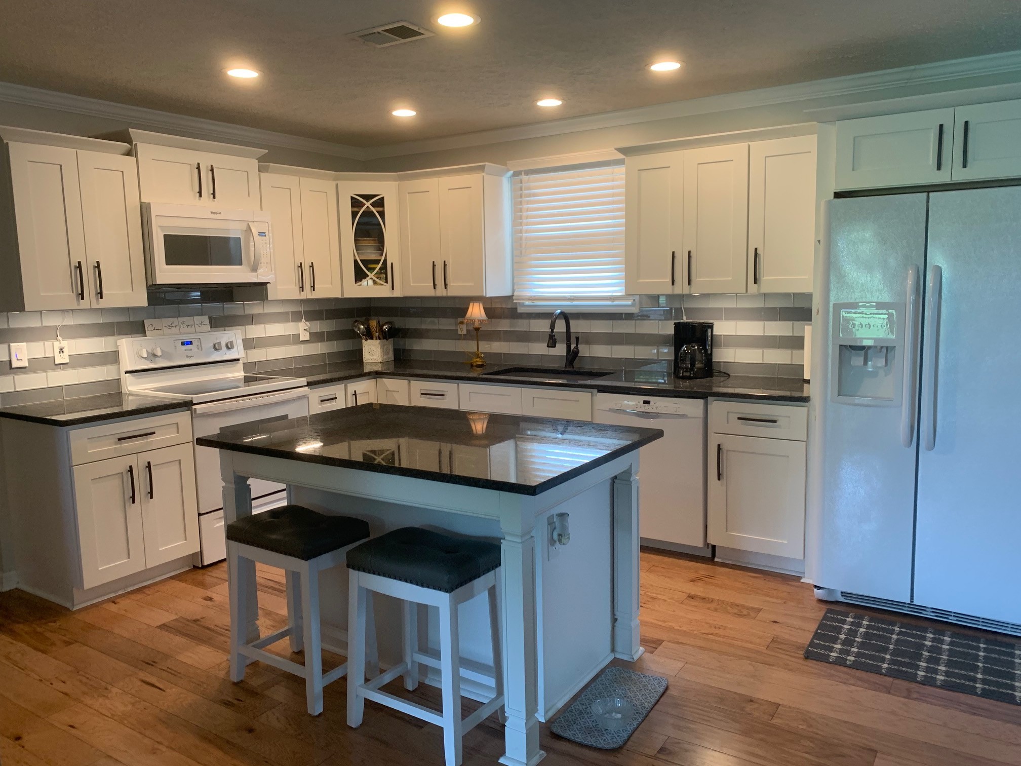 3078 Big Springs Road Lebanon, TN 37090 - Photo 7 of 24 a kitchen with stainless steel appliances granite countertop a sink a stove a refrigerator and island with wooden floor