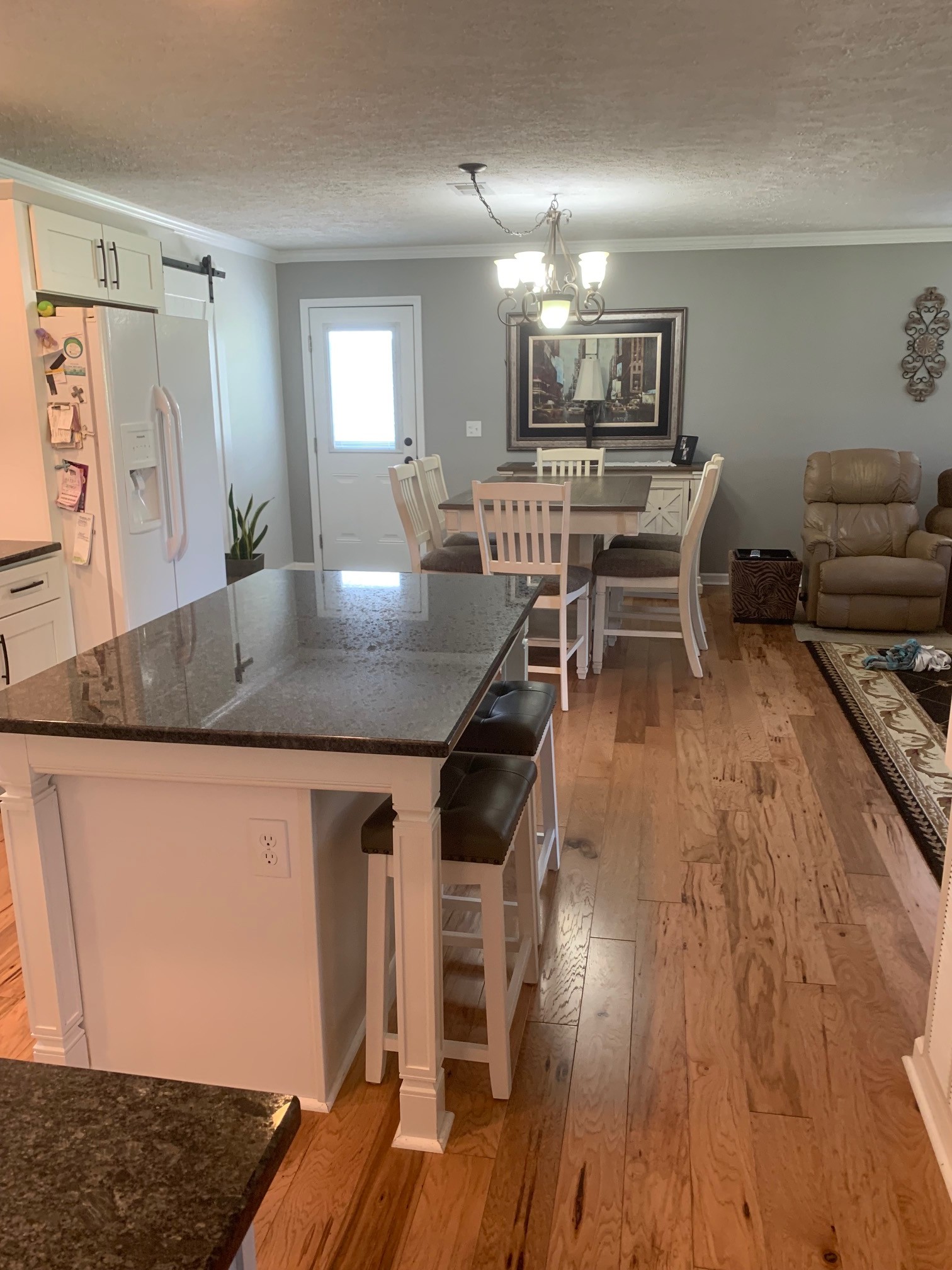 3078 Big Springs Road Lebanon, TN 37090 - Photo 8 of 24 a kitchen with stainless steel appliances granite countertop a stove a sink dishwasher and a dining table with wooden floor