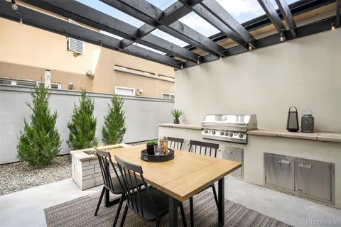 a view of a dinning table and chairs in the balcony