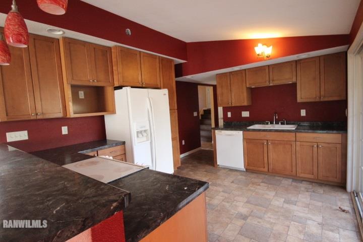 986 West Angle Road Freeport, IL 61032 - Photo 4 of 16 a kitchen with a sink refrigerator and cabinets