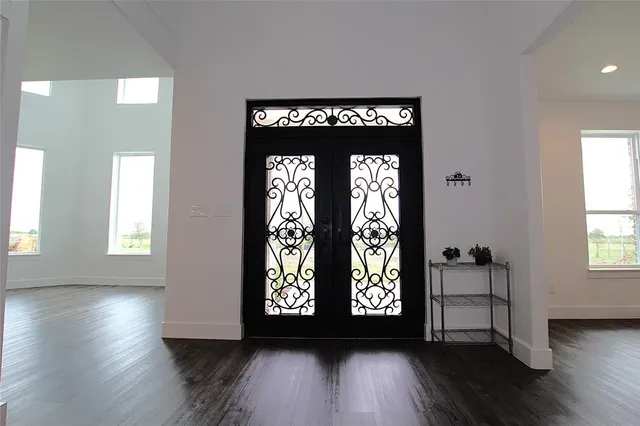 a view of wooden floor and windows in a room