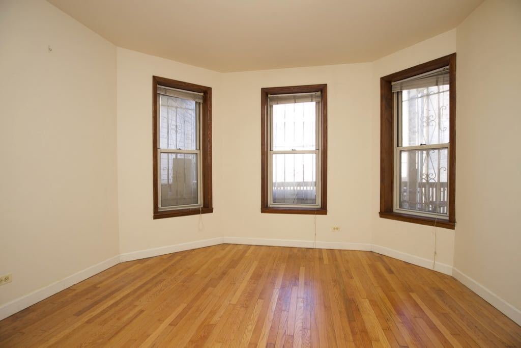 6713 North Sheridan Road, Unit 1N Chicago, IL 60626 - Photo 16 of 20 an empty room with wooden floor and windows