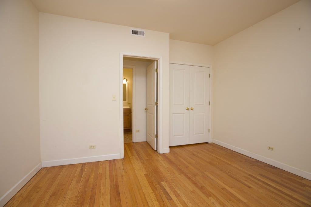 6713 North Sheridan Road, Unit 1N Chicago, IL 60626 - Photo 17 of 20 an empty room with wooden floor and white walls