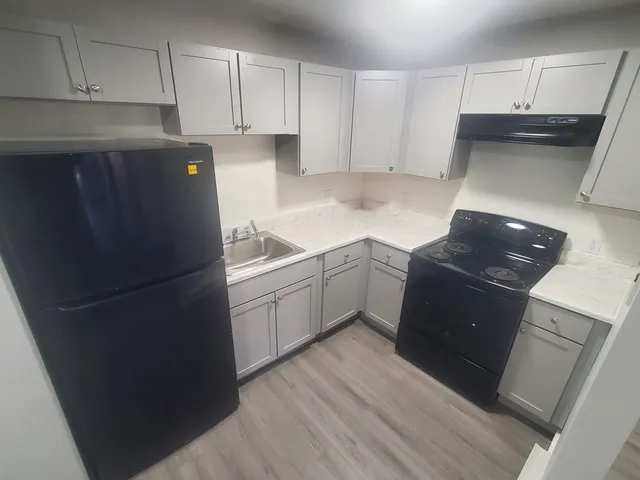a kitchen with a sink and a refrigerator
