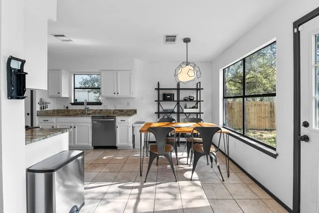 a kitchen with a sink a counter top space and stainless steel appliances