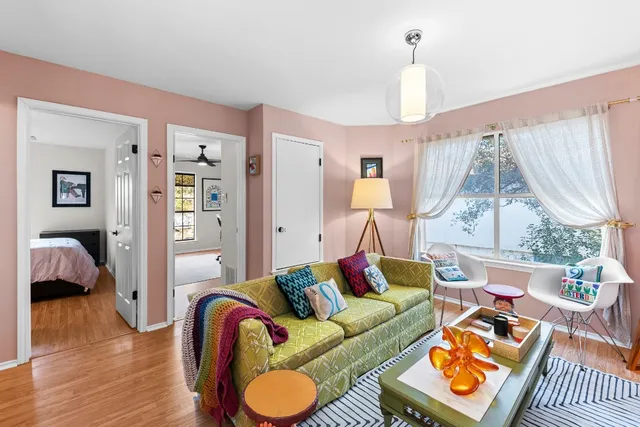 a living room with furniture and wooden floor