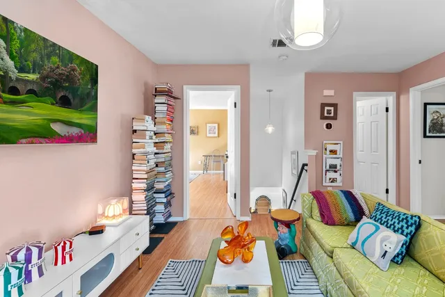 a bedroom with furniture and a wooden floor
