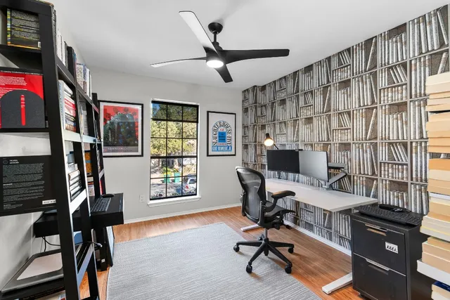 a view of a livingroom with workspace and a window