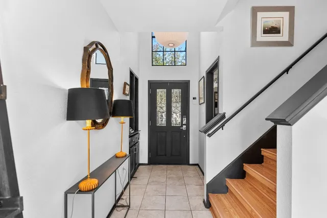 a view of staircase with furniture and a window