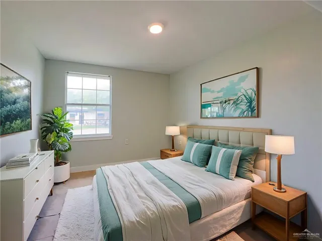 a bedroom with a bed and a potted plant