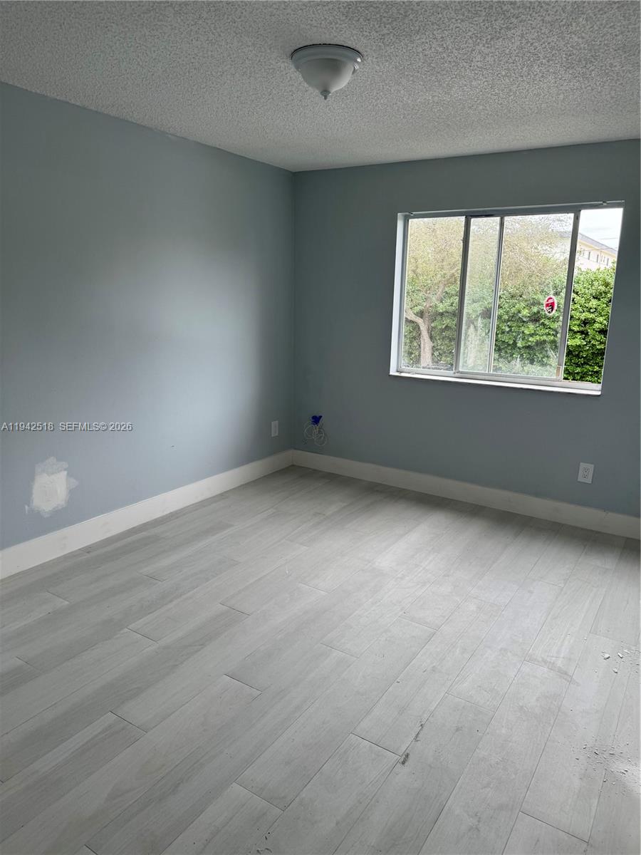 440 South Park Road, Unit 4207 Hollywood, FL 33021 - Photo 2 of 14 an empty room with wooden floor and windows
