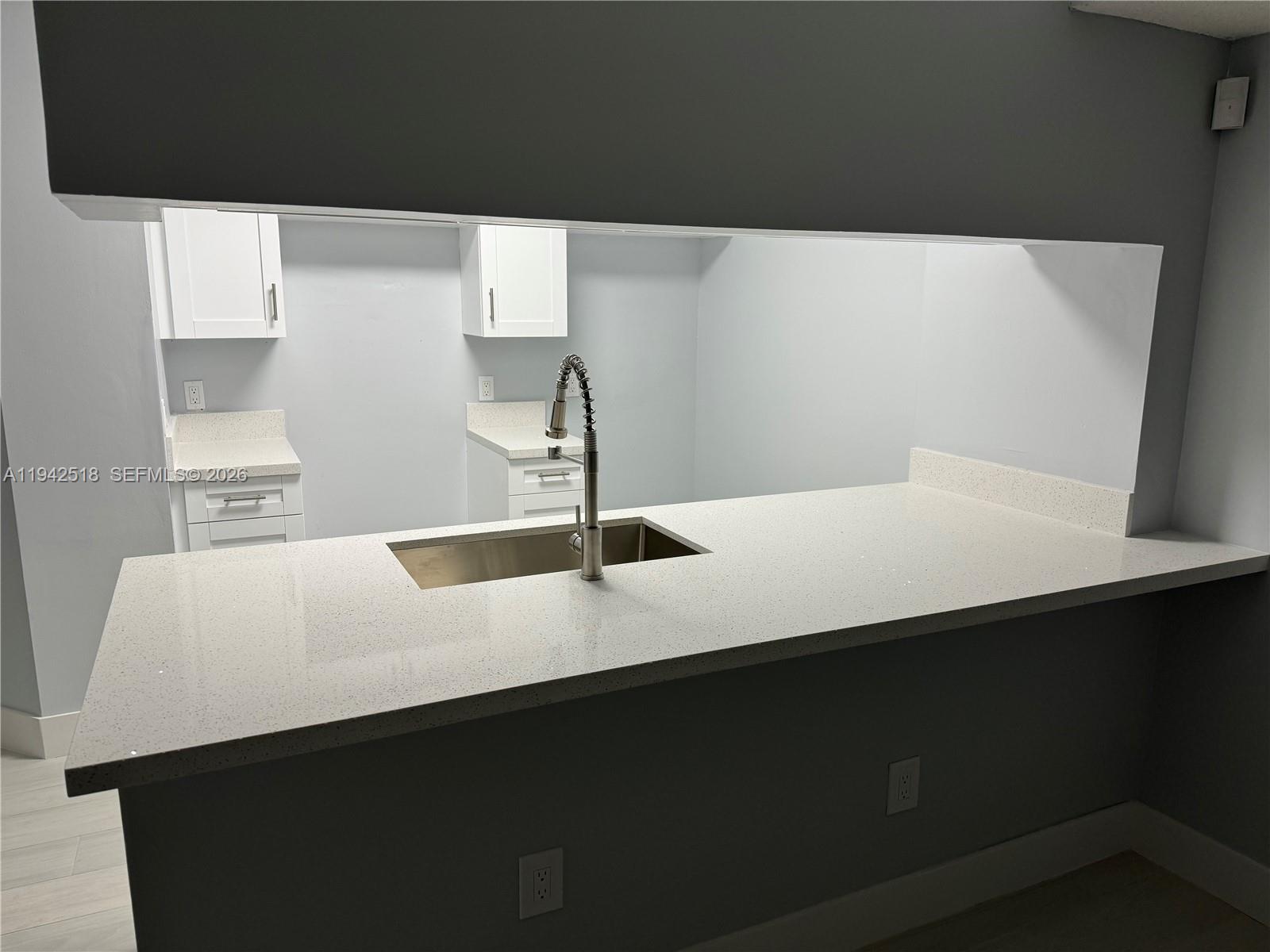 440 South Park Road, Unit 4207 Hollywood, FL 33021 - Photo 5 of 14 a kitchen with a sink and a refrigerator