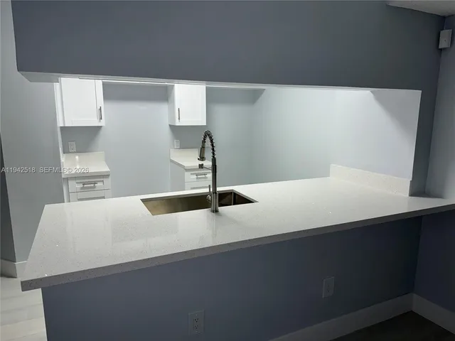 a kitchen with a sink and a refrigerator