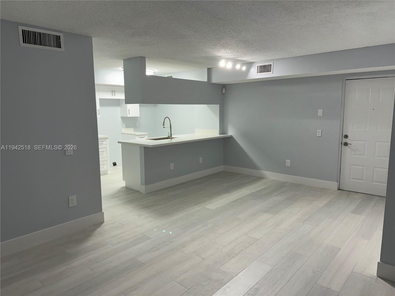 440 South Park Road, Unit 4207 Hollywood, FL 33021 - Photo 10 of 14 a view of an empty room with cabinet and wooden floor