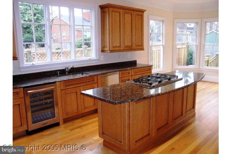 5711 Ridgefield Road Bethesda, MD 20816 - Photo 2 of 6 a kitchen with stainless steel appliances granite countertop a stove a sink and a microwave