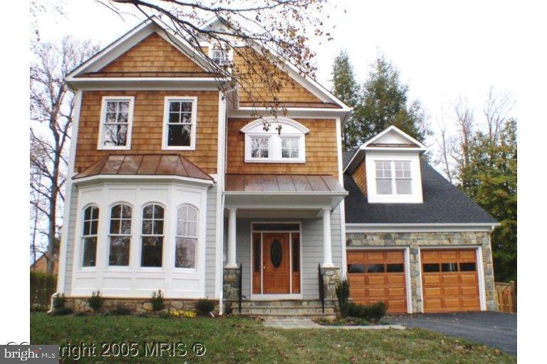 5711 Ridgefield Road Bethesda, MD 20816 - Photo 3 of 6 a front view of a house with a yard