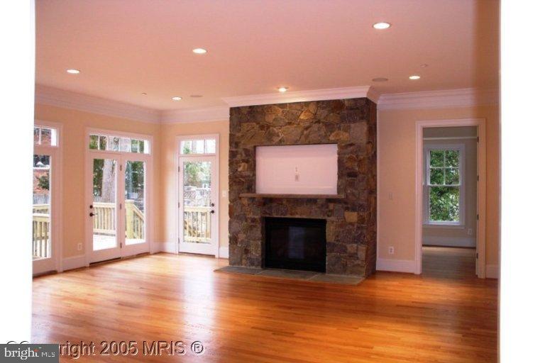 5711 Ridgefield Road Bethesda, MD 20816 - Photo 6 of 6 a view of a livingroom with a fireplace a fireplace and wooden floor