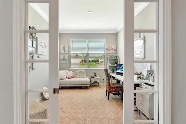 a living room with furniture and a floor to ceiling window