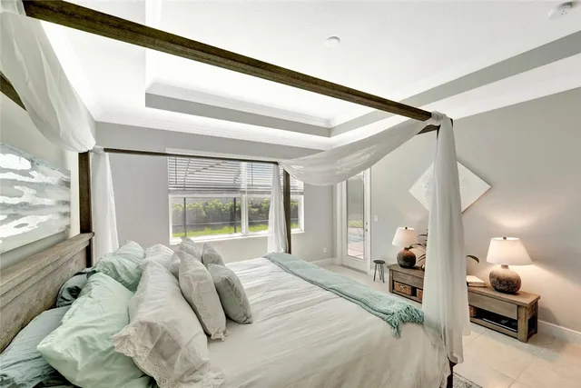 a bedroom with a large bed and a large window