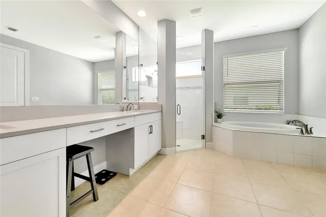 a bathroom with a tub sink and mirror