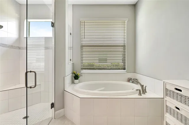 a bathroom with a tub and a shower