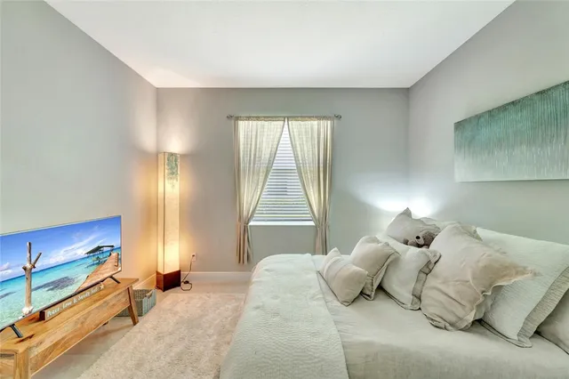 a bedroom with a large bed and a window