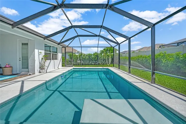 a view of a backyard with a garden and entertaining space