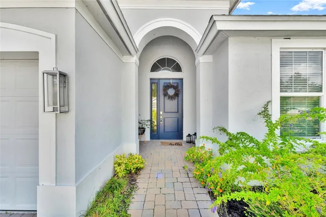 an aerial view of residential houses with outdoor space and pool