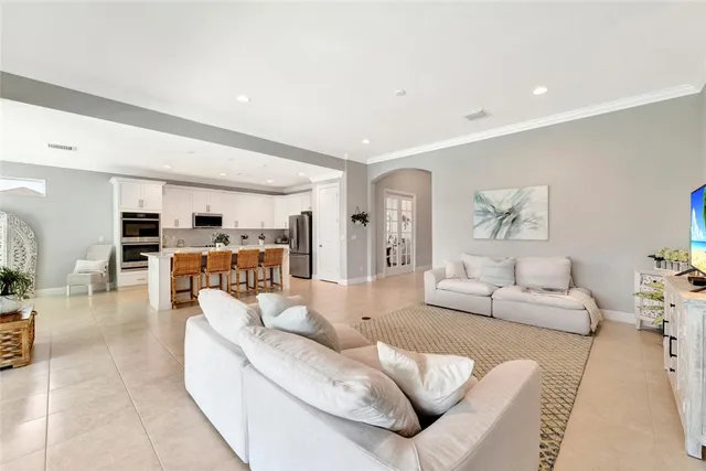 a living room with furniture and view of kitchen
