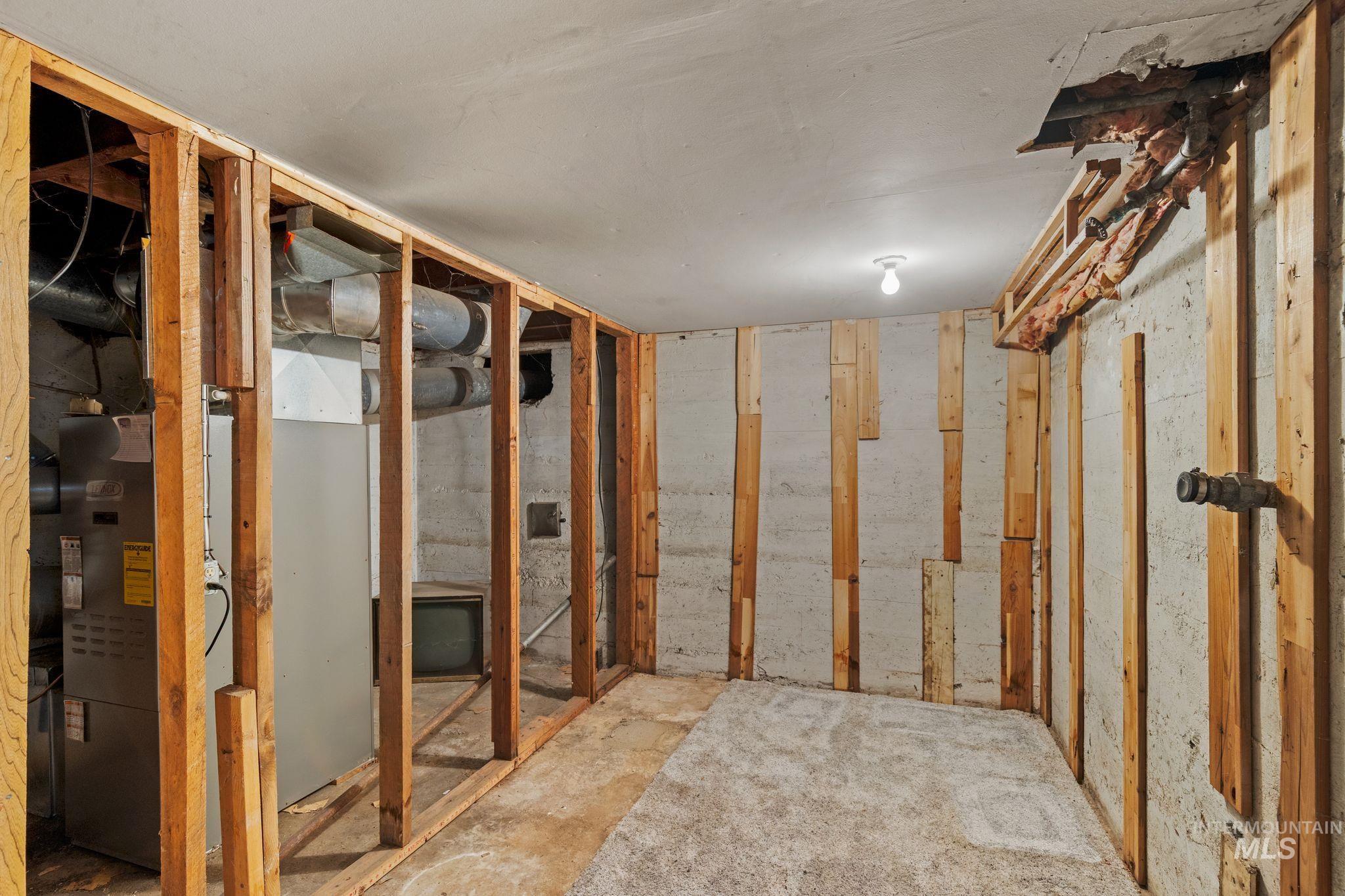 2255 Appleside Boulevard Clarkston, WA 99403 - Photo 26 of 41 Unfinished basement featuring exposed wood framing, concrete flooring, and an exposed wood staircase