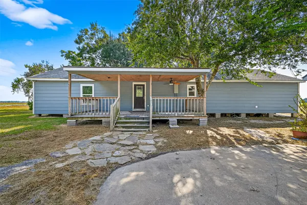 a view of a house with a yard and deck