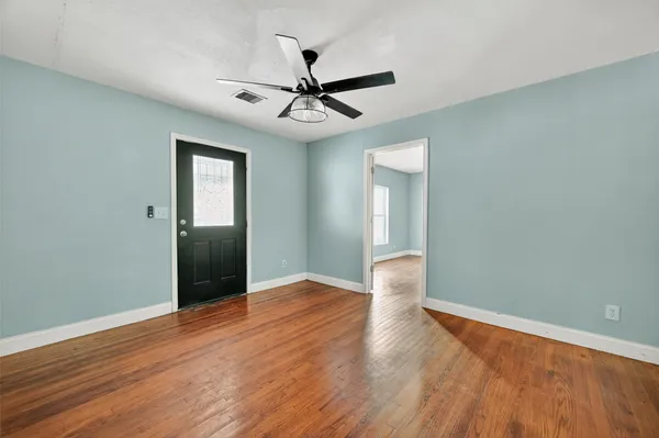 wooden floor in an empty room with a window
