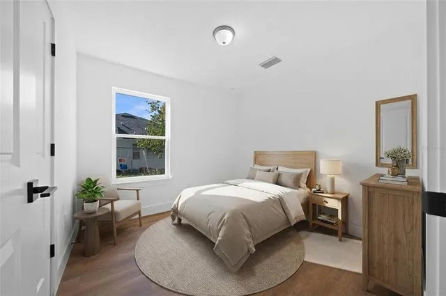 a bedroom with a bed and a window