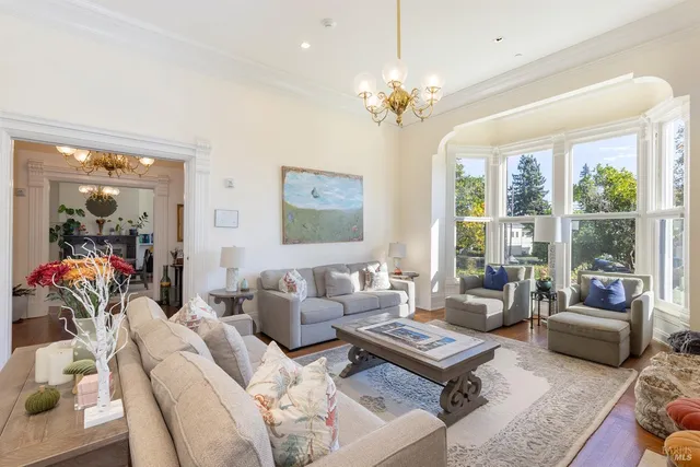 a living room with furniture and a chandelier