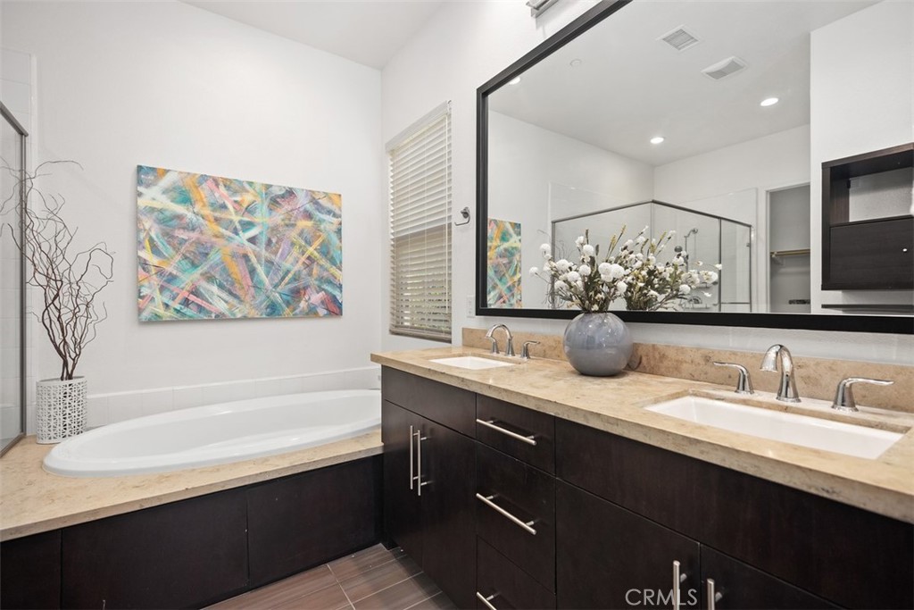 3 Planeo Rancho Mission Viejo, CA 92694 - Photo 22 of 37 a bathroom with a sink a large mirror and a bathtub