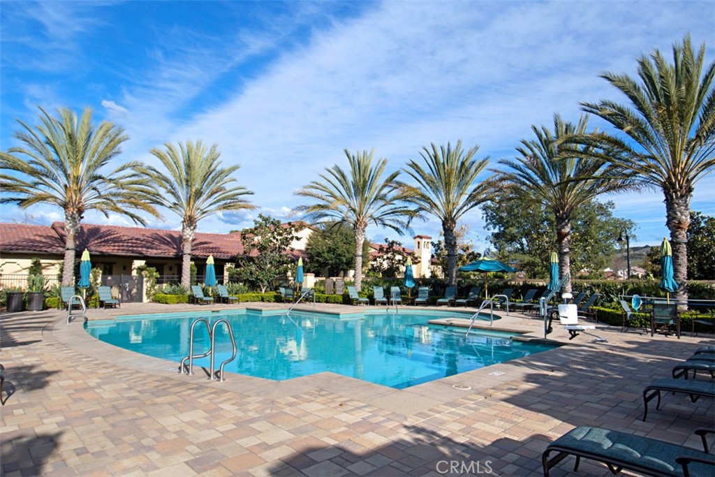 3 Planeo Rancho Mission Viejo, CA 92694 - Photo 35 of 37 a view of a swimming pool with a table and chairs