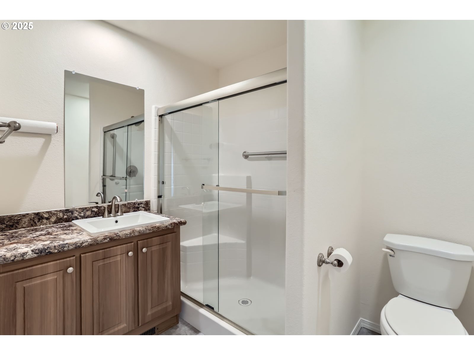 19605 River Road, Unit 3 Gladstone, OR 97027 - Photo 11 of 13 a bathroom with a granite countertop sink a toilet a mirror and shower