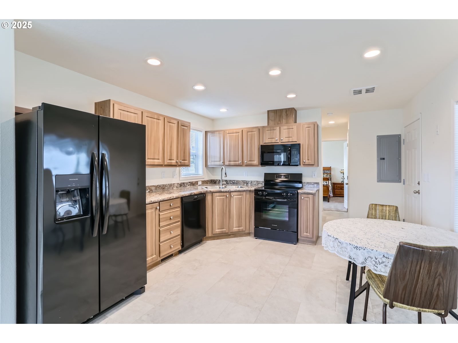19605 River Road, Unit 3 Gladstone, OR 97027 - Photo 7 of 13 a kitchen with refrigerator a sink and chairs