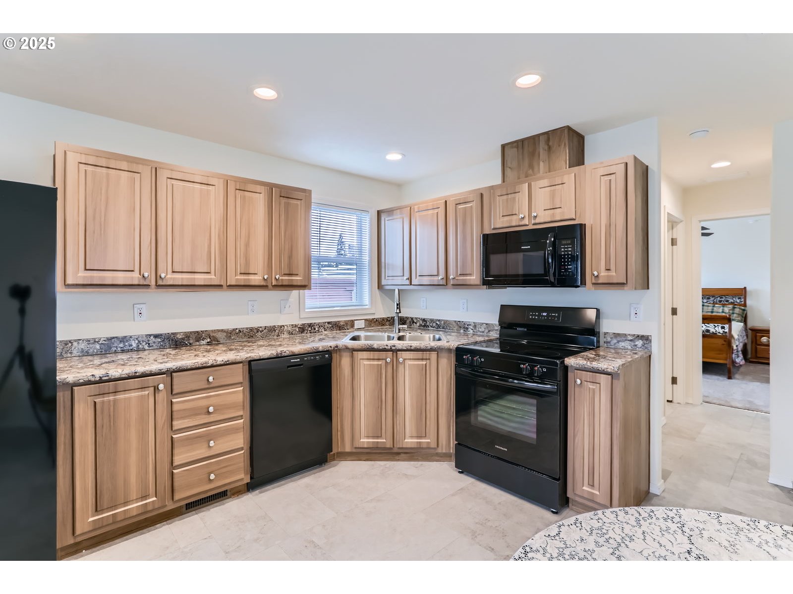 19605 River Road, Unit 3 Gladstone, OR 97027 - Photo 8 of 13 a kitchen with stainless steel appliances granite countertop a stove top oven a sink dishwasher and a microwave with wooden cabinets