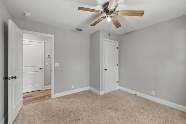 a view of room with a ceiling fan