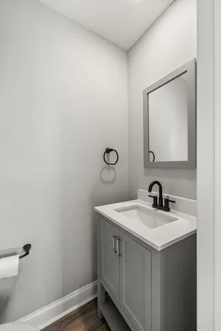 a bathroom with a sink toilet and mirror