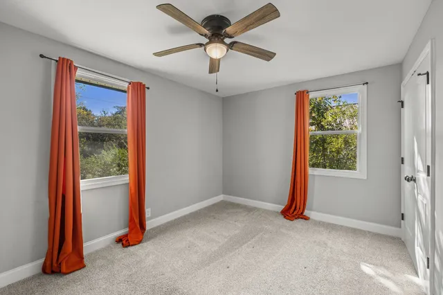 a view of room with window and ceiling fan