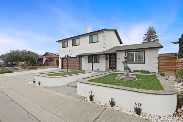 a front view of a house with garden