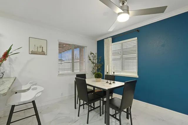 a view of a dining room with furniture and window
