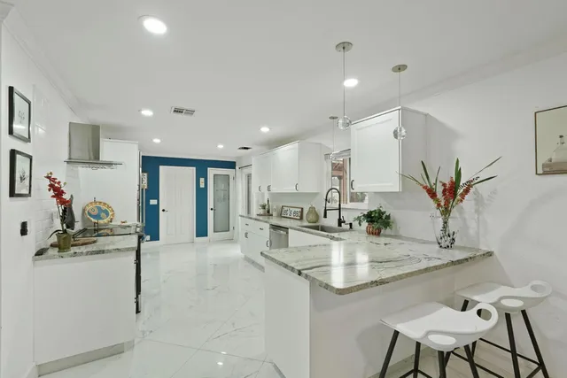 a kitchen with stainless steel appliances granite countertop a sink stove and refrigerator