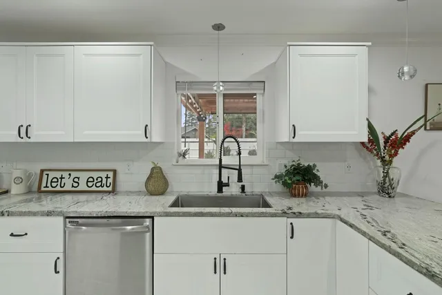 a kitchen with a sink a stove and cabinets