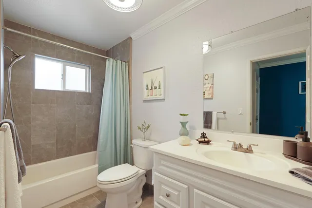 a view of a chairs and table in the patio with a barbeque