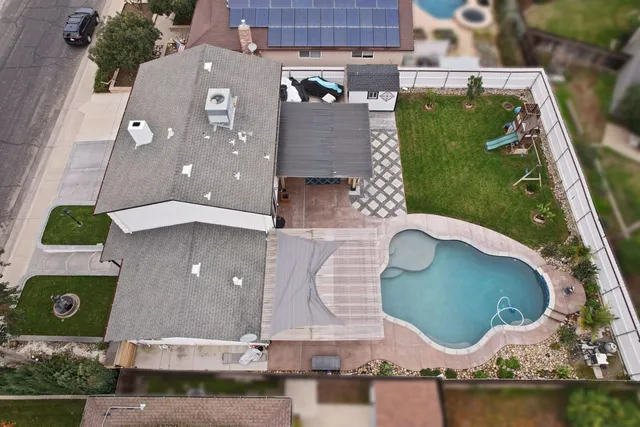 a view of a house with swimming pool and a yard