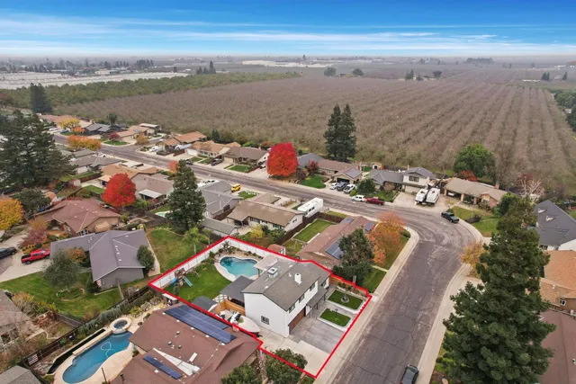 an aerial view of residential houses with outdoor space