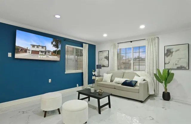 a living room with furniture potted plant and a window